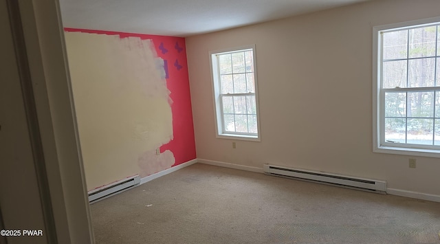 empty room featuring baseboards, light carpet, and baseboard heating