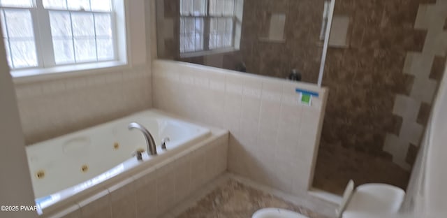 full bathroom featuring a tub with jets