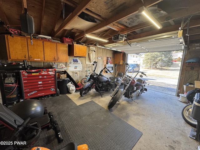 garage with a workshop area and a garage door opener