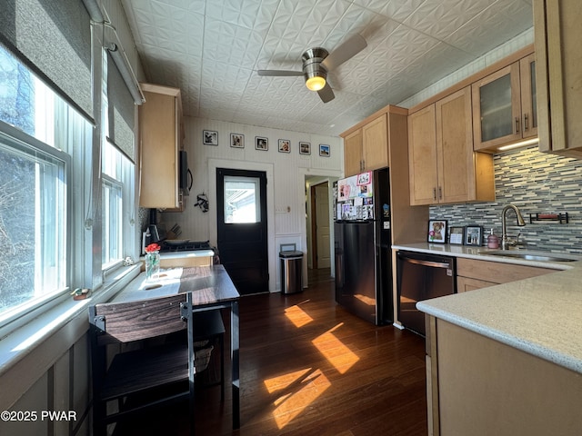 kitchen featuring light brown cabinets, a sink, light countertops, black appliances, and an ornate ceiling