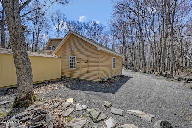 exterior space featuring a storage unit and an outdoor structure