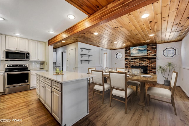 kitchen featuring appliances with stainless steel finishes, light wood-type flooring, and white cabinets