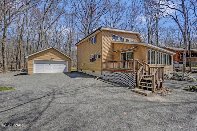 view of home's exterior with an outdoor structure and a detached garage