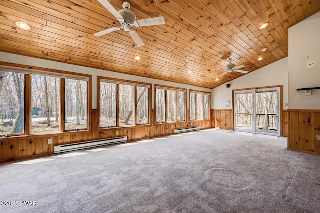 unfurnished living room featuring a baseboard heating unit, a ceiling fan, wainscoting, and wood ceiling