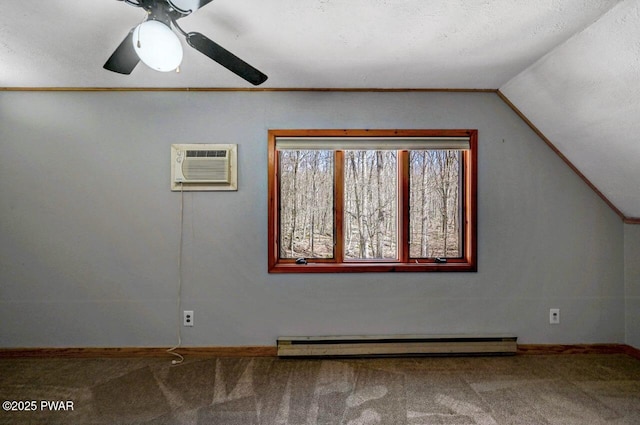 additional living space featuring vaulted ceiling, carpet flooring, a baseboard heating unit, and baseboards