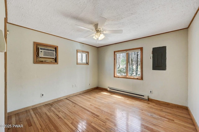 unfurnished room with a wall unit AC, ceiling fan, electric panel, a baseboard heating unit, and light wood finished floors