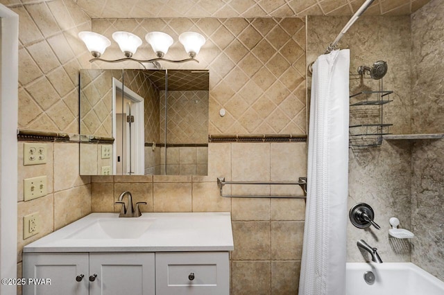 bathroom with tile walls, shower / tub combo, and vanity