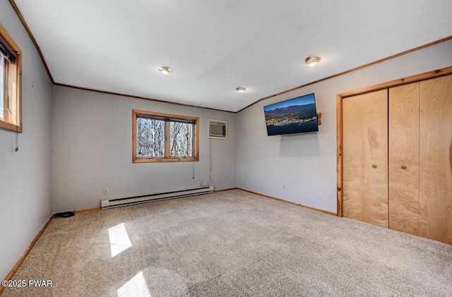 unfurnished bedroom featuring baseboard heating, carpet flooring, an AC wall unit, baseboards, and crown molding