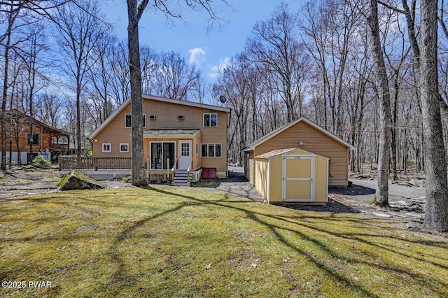 rear view of house with an outdoor structure, a wooden deck, entry steps, a shed, and a lawn