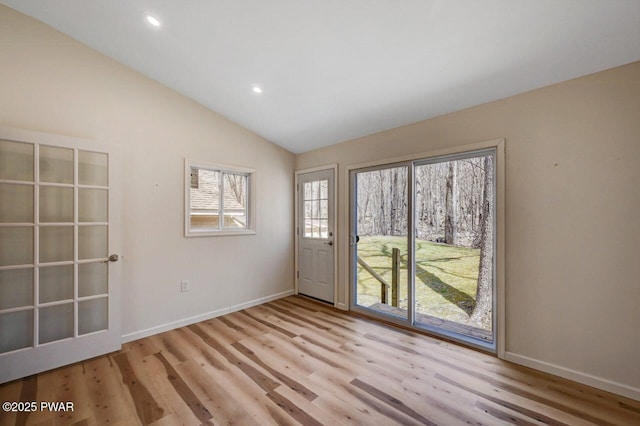entryway featuring wood finished floors, recessed lighting, vaulted ceiling, and baseboards