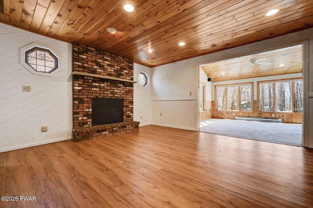 unfurnished living room featuring a brick fireplace, wooden ceiling, wood finished floors, and a baseboard radiator