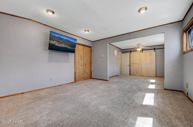 unfurnished bedroom with crown molding, baseboards, and carpet floors