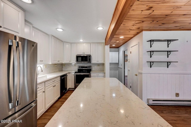 kitchen featuring dark wood finished floors, appliances with stainless steel finishes, a baseboard radiator, and a sink