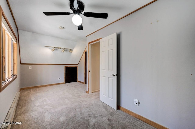 spare room with baseboards, ceiling fan, and carpet flooring