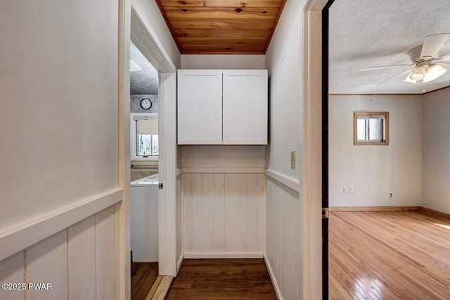 interior space featuring wood finished floors and a wainscoted wall