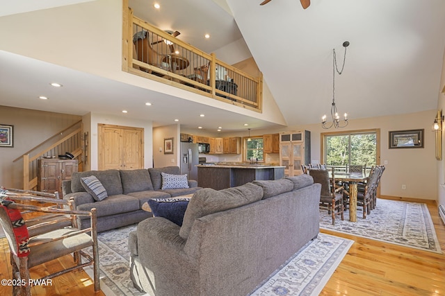980 Long Ridge Rd, Hawley, PA 18428 - living area with stairs, light wood-style floors, high vaulted ceiling, recessed lighting, and a chandelier