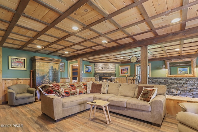 980 Long Ridge Rd, Hawley, PA 18428 - living room with a wooden ceiling with exposed beams, coffered ceiling, wood finished floors, wainscoting, and a stone fireplace