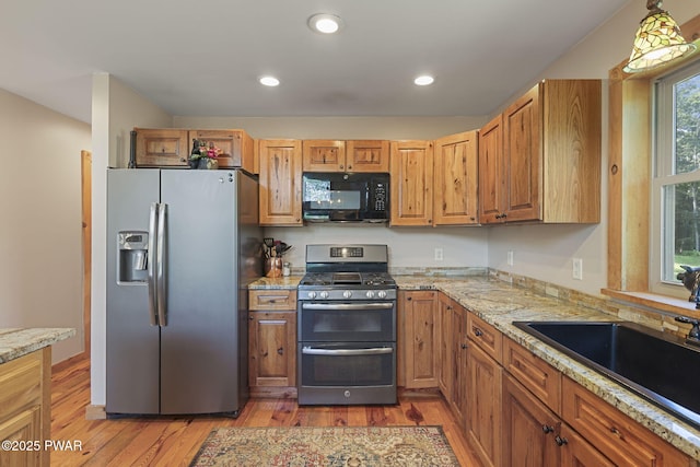 980 Long Ridge Rd, Hawley, PA 18428 - kitchen featuring stainless steel appliances, light wood-type flooring, light stone countertops, recessed lighting, and brown cabinets