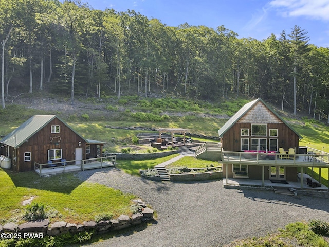 980 Long Ridge Rd, Hawley, PA 18428 - view of front of house with a wooden deck, a patio area, and a wooded view