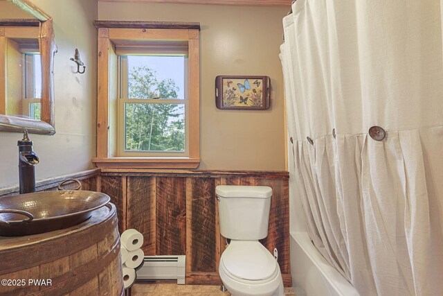 980 Long Ridge Rd, Hawley, PA 18428 - bathroom with a baseboard radiator, a wainscoted wall, and shower / bath combo