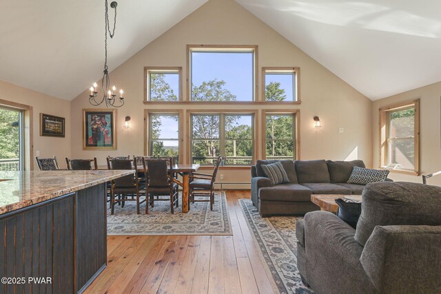 980 Long Ridge Rd, Hawley, PA 18428 - living area featuring high vaulted ceiling, a chandelier, and light wood finished floors