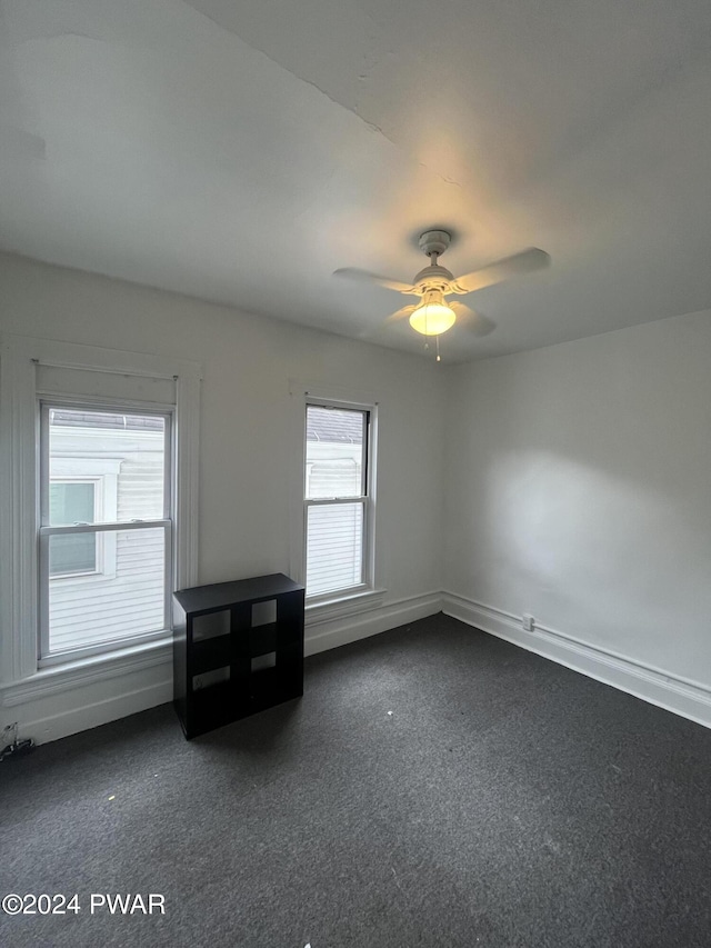 carpeted empty room featuring ceiling fan