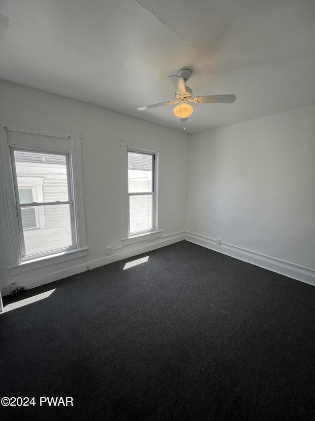 spare room with carpet floors and ceiling fan