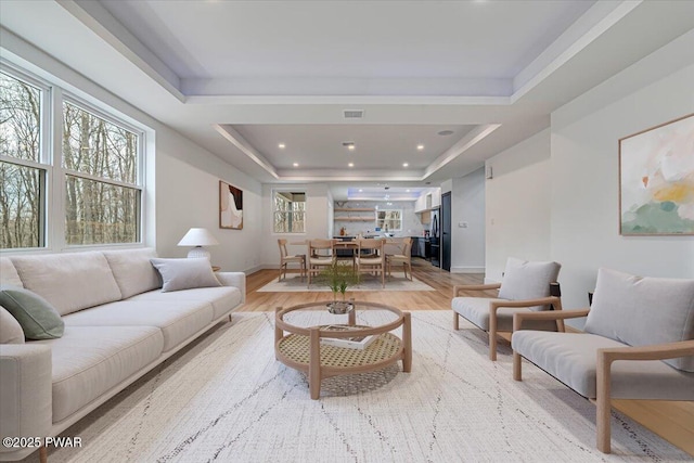 328 Forest Dr, Lords Valley, PA 18428 - living room featuring a tray ceiling, light wood-style flooring, and recessed lighting