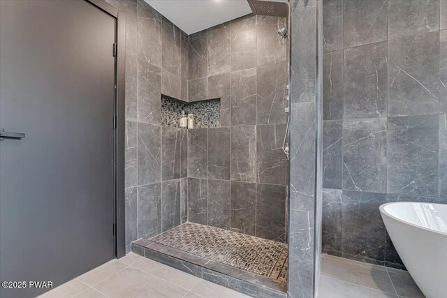 328 Forest Dr, Lords Valley, PA 18428 - bathroom with tiled shower, a freestanding tub, tile patterned flooring, and tile walls