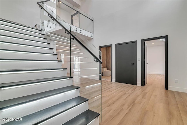 328 Forest Dr, Lords Valley, PA 18428 - stairway featuring a high ceiling and wood finished floors