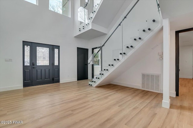328 Forest Dr, Lords Valley, PA 18428 - entrance foyer featuring light wood-style floors, stairway, a towering ceiling, and healthy amount of natural light