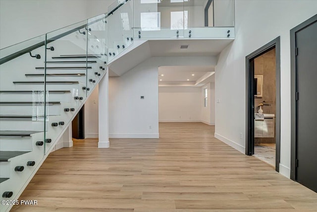 328 Forest Dr, Lords Valley, PA 18428 - staircase featuring wood finished floors, a high ceiling, and recessed lighting