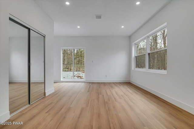 328 Forest Dr, Lords Valley, PA 18428 - unfurnished bedroom featuring multiple windows, recessed lighting, light wood-style floors, and a closet