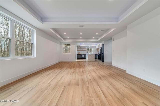 328 Forest Dr, Lords Valley, PA 18428 - unfurnished living room featuring a tray ceiling, light wood finished floors, and recessed lighting