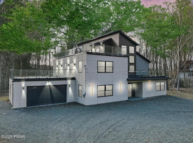 328 Forest Dr, Lords Valley, PA 18428 - back of property featuring an attached garage and gravel driveway