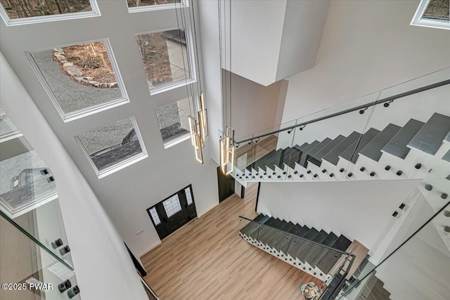328 Forest Dr, Lords Valley, PA 18428 - staircase featuring a towering ceiling and wood finished floors