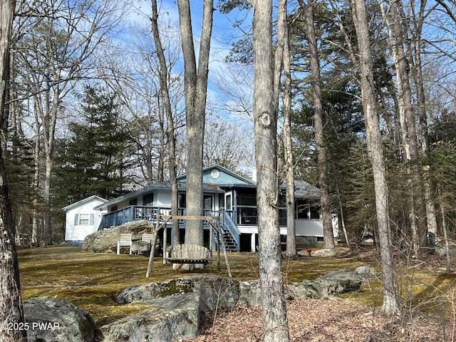 view of front of property with metal roof and stairway