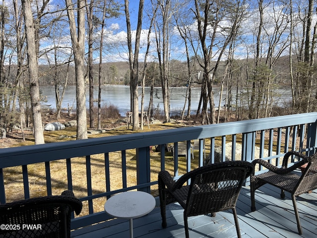 wooden terrace featuring a water view