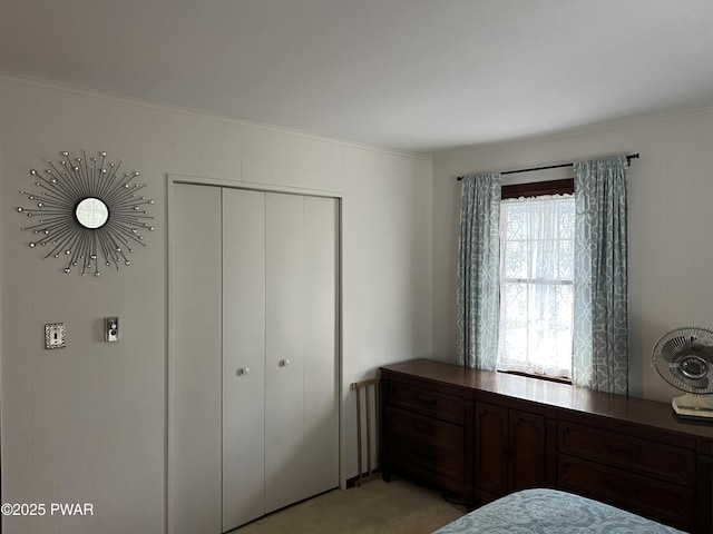 bedroom featuring light carpet and a closet