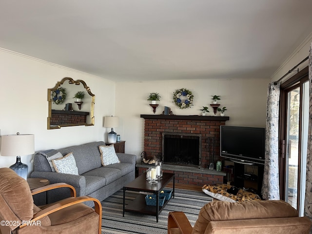 living area with ornamental molding and a fireplace