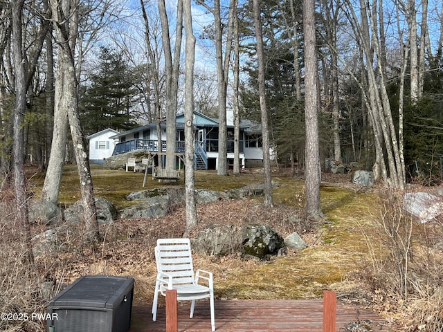 view of yard featuring a deck and stairway