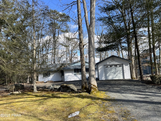 view of property exterior featuring a garage and driveway