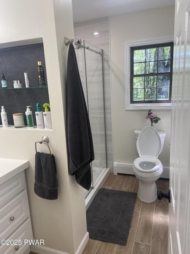 110 Stonefield Rd, Milford, PA 18337 - bathroom featuring a baseboard radiator, wood finished floors, a shower stall, and vanity