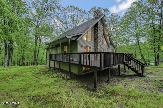 107 Musket Dr, Lackawaxen, PA 18435 - view of side of property with a wooden deck, a chimney, stairway, and roof with shingles
