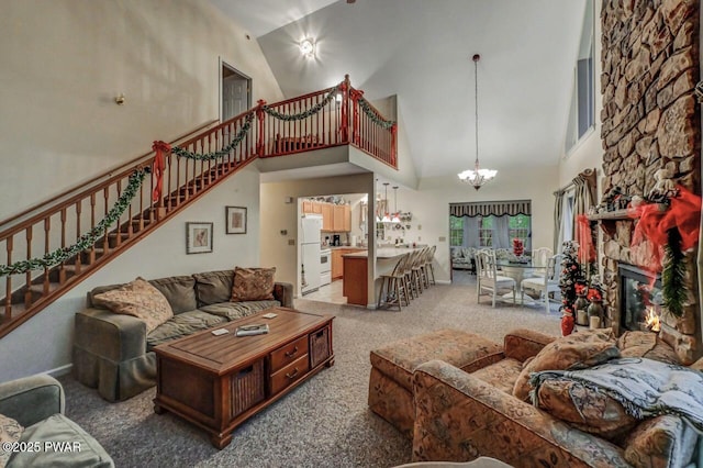 107 Musket Dr, Lackawaxen, PA 18435 - living area with high vaulted ceiling, light carpet, stairway, a chandelier, and a fireplace