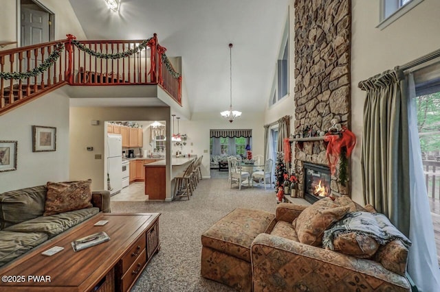 107 Musket Dr, Lackawaxen, PA 18435 - living area featuring high vaulted ceiling, light colored carpet, a chandelier, stairs, and a stone fireplace