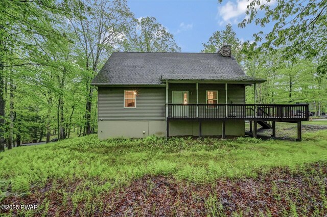 107 Musket Dr, Lackawaxen, PA 18435 - view of front facade with a chimney and a wooden deck