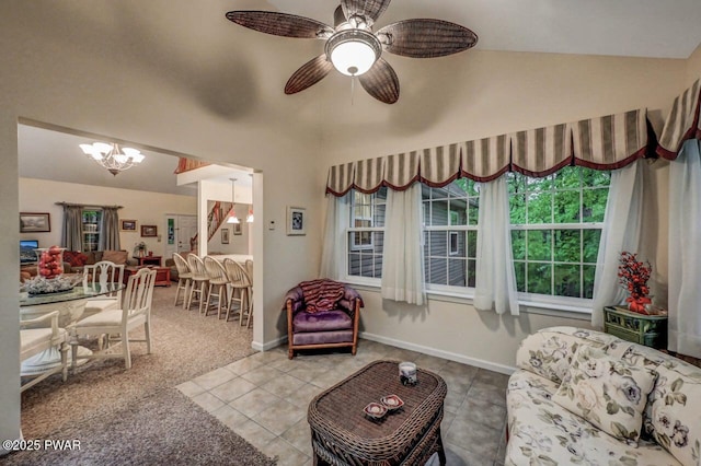107 Musket Dr, Lackawaxen, PA 18435 - tiled living area with a chandelier, a ceiling fan, high vaulted ceiling, and baseboards