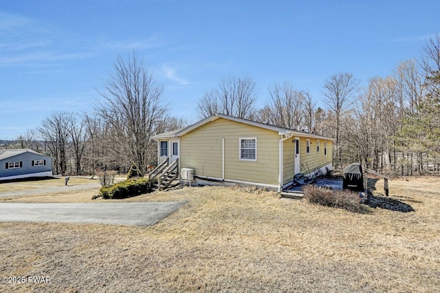 view of side of property with entry steps