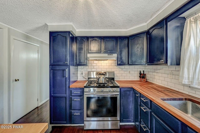 kitchen featuring stainless steel range with gas cooktop, dark wood finished floors, blue cabinetry, under cabinet range hood, and wood counters